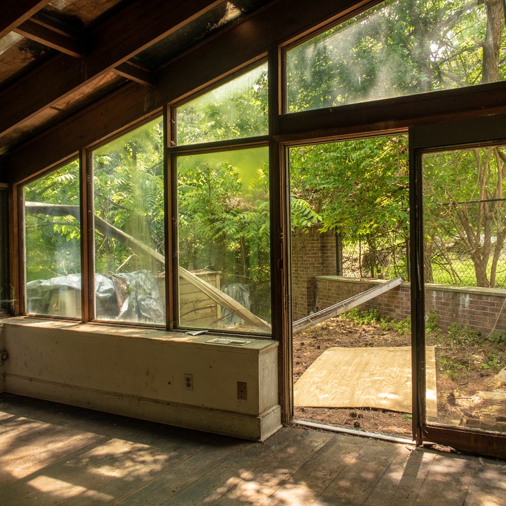 Abandoned room with outdoor view and broken glass