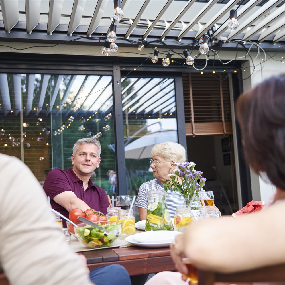 Adults gathered around a table with salad