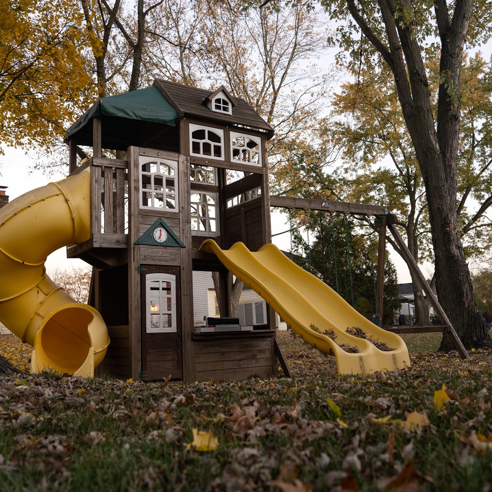Backyard playground and colorful autumn leaves