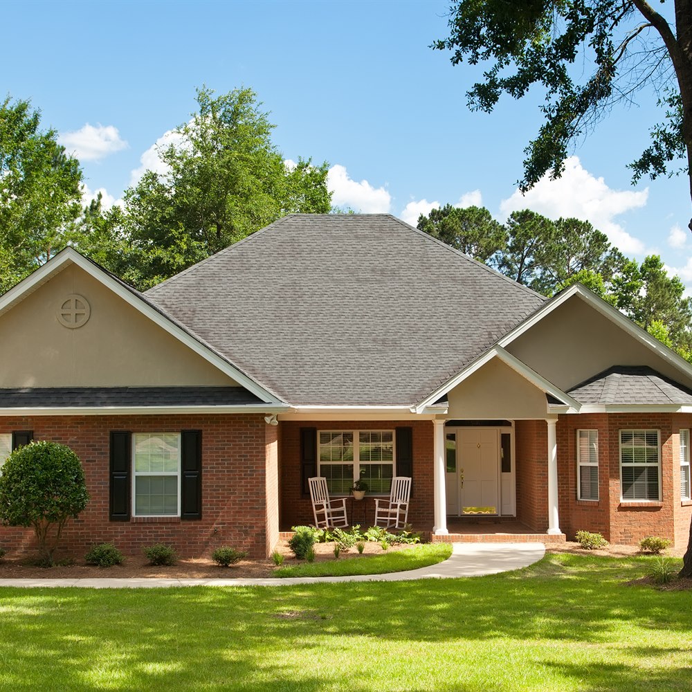 brick-home-with-a-green-front-lawn Brick home with a green front lawn