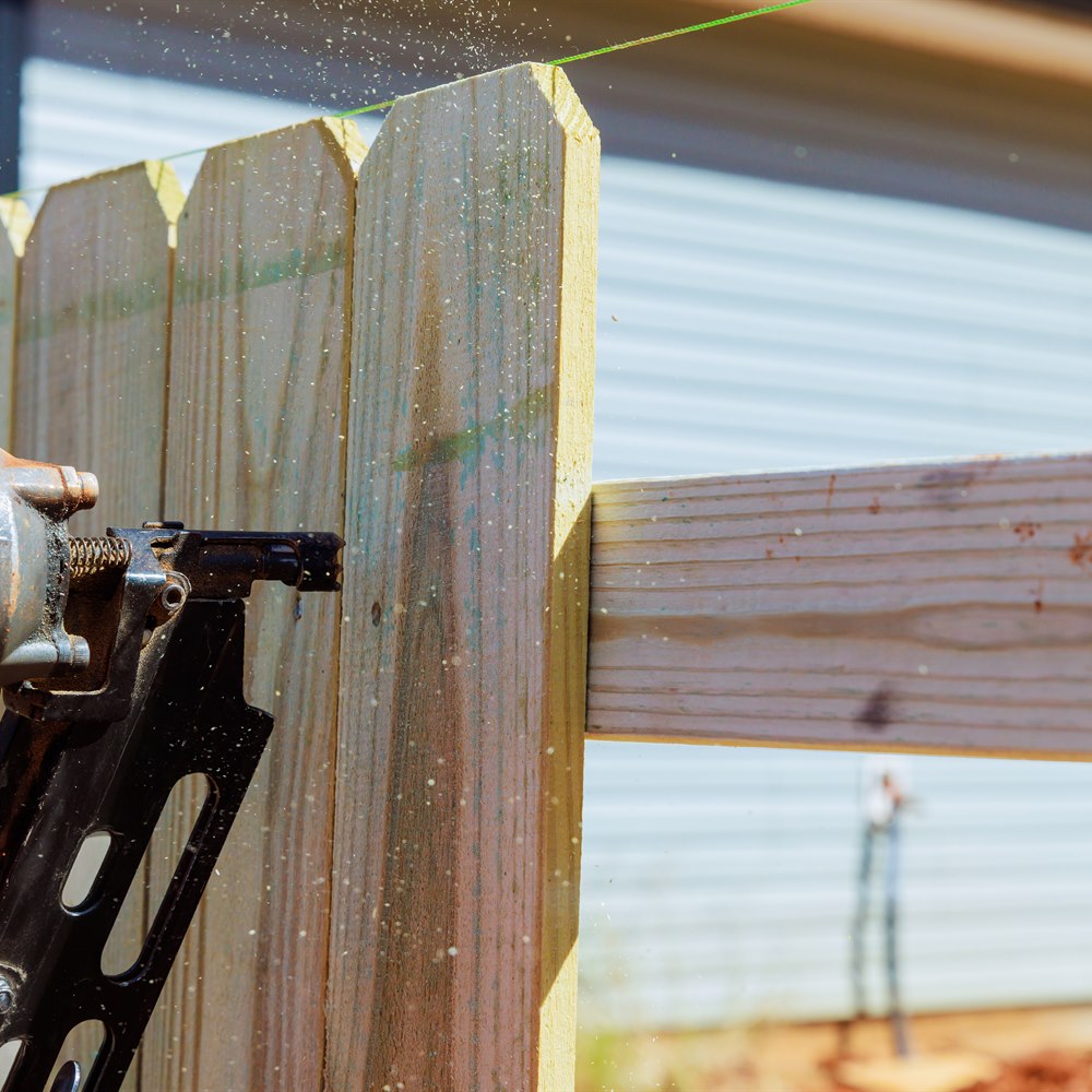 Building a wooden fence using a nail gun