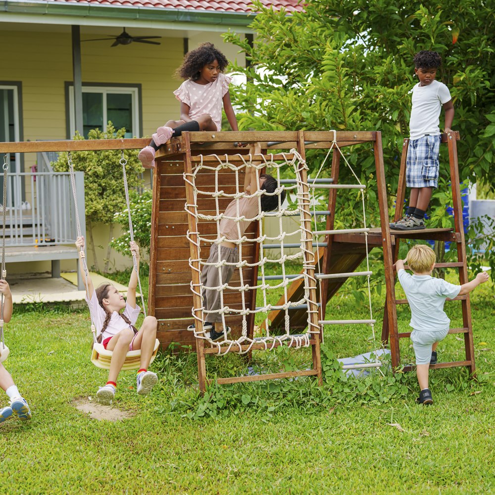 Children playing on a wooden playset outside