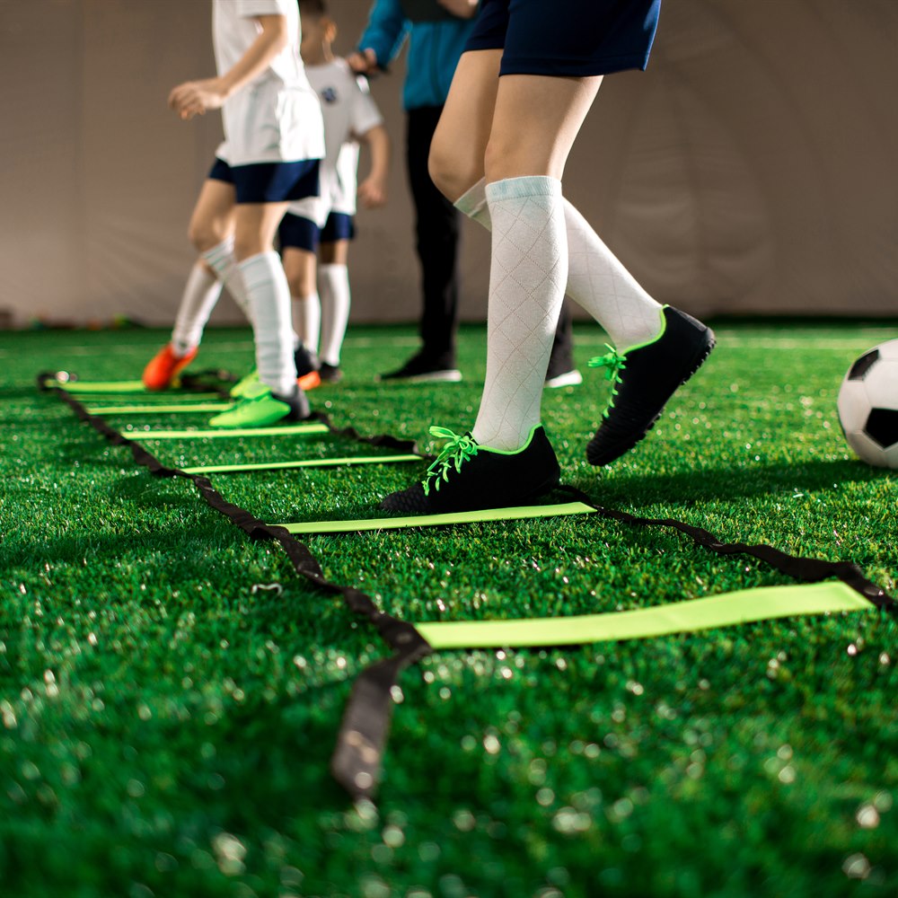 children-training-soccer-skills-on-artificial-turf Children training soccer skills on artificial turf