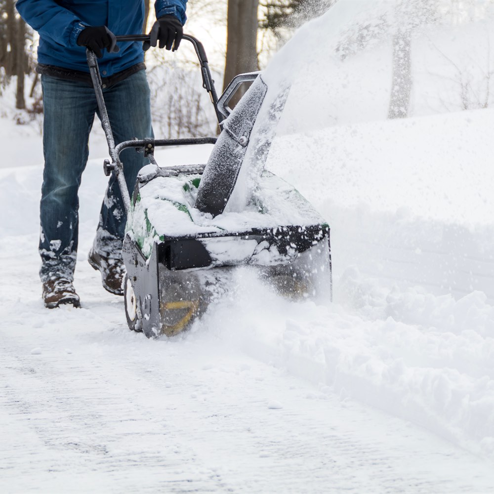 clearing-a-driveway-with-a-snow-blower Clearing a driveway with a snow blower