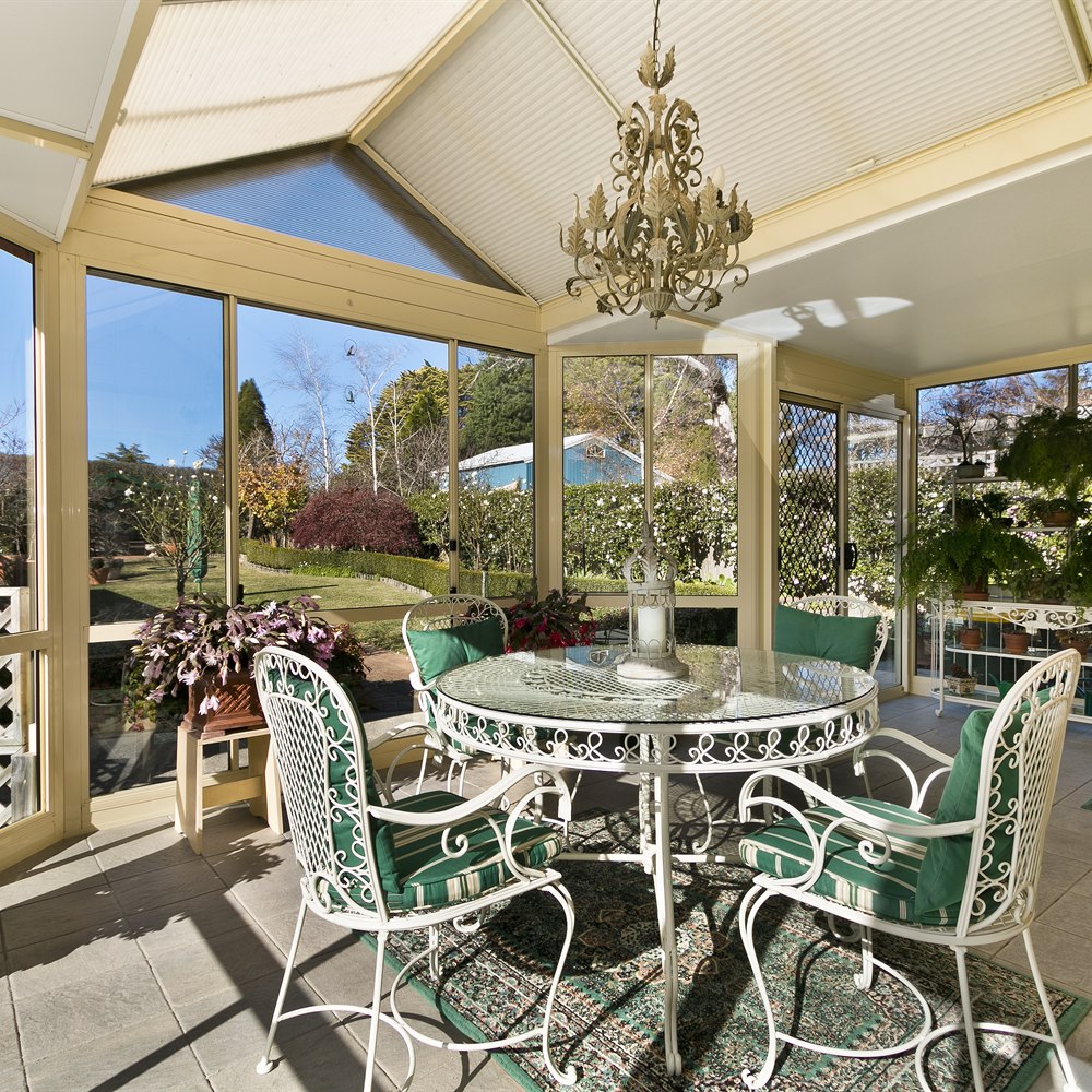 comfortable-sunroom-with-garden-view-and-ornate Comfortable sunroom with garden view and ornate