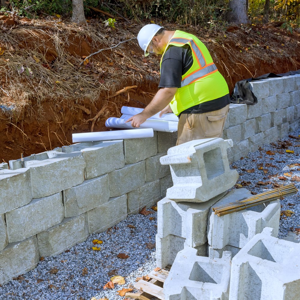 construction-worker-building-a-retaining-wall Construction worker building a retaining wall