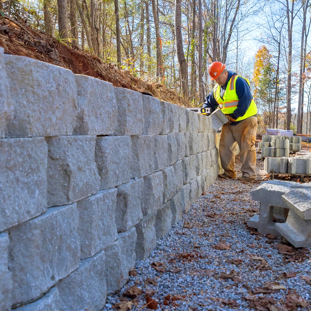 Construction worker building retaining wall outside