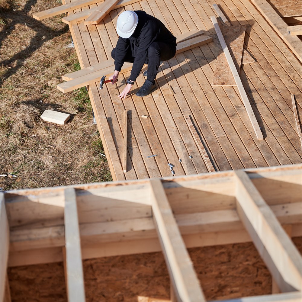 construction-worker-building-wooden-structure Construction worker building wooden structure