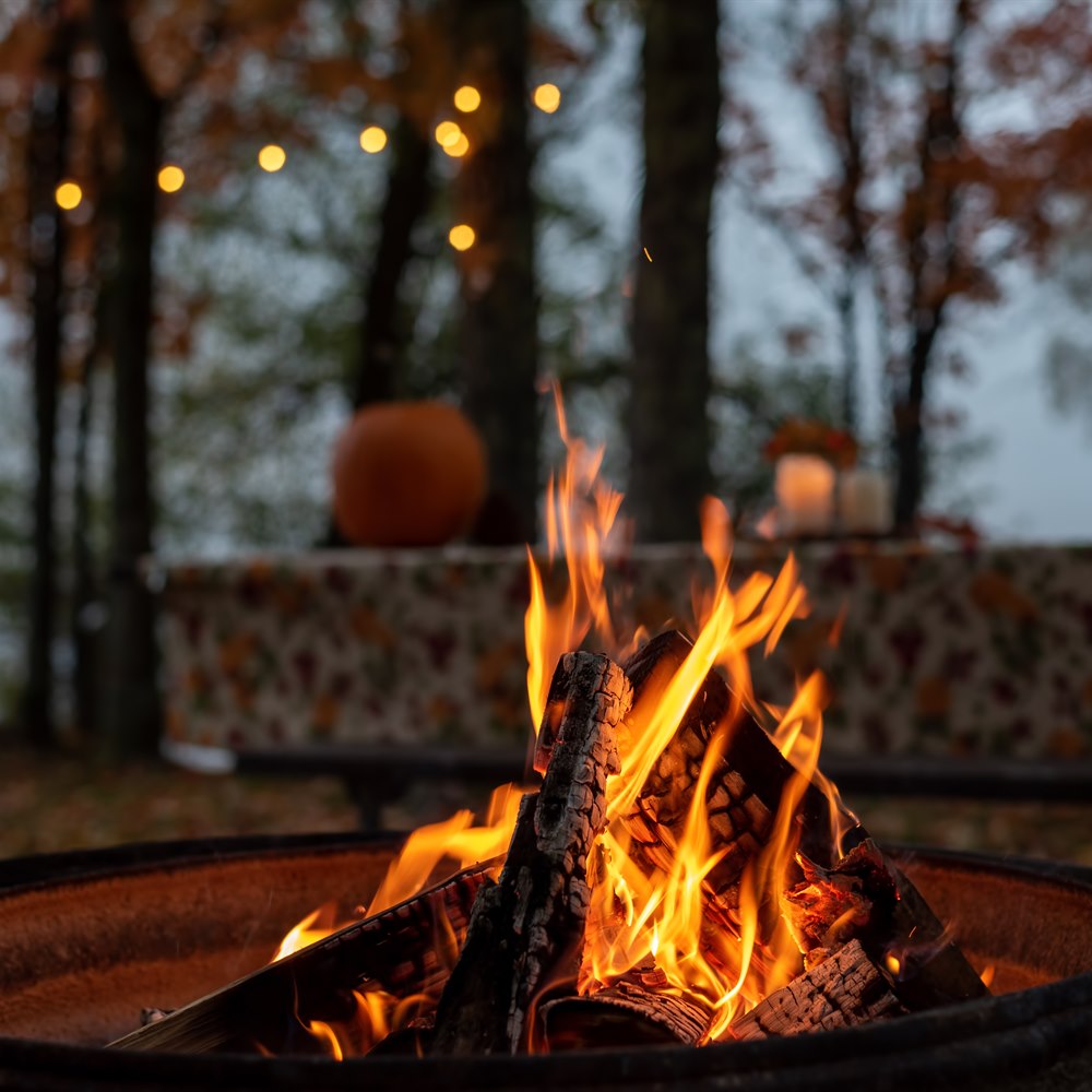cozy-autumn-campfire-scene-with-pumpkin-decor Cozy autumn campfire scene with pumpkin decor