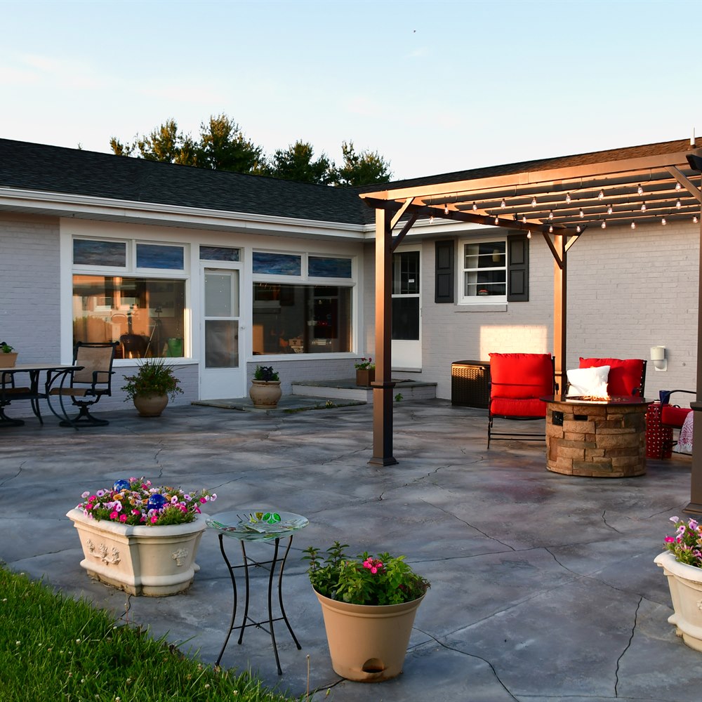 Cozy outdoor patio with red cushions and flowers