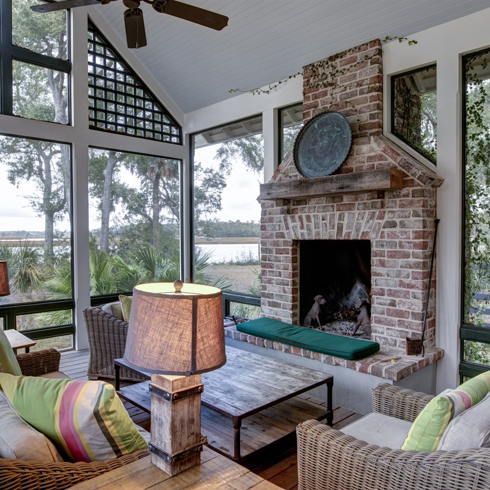 Cozy sun room with brick fireplace