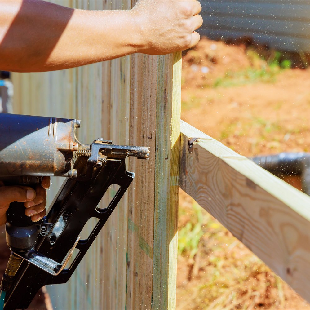 craftsman-uses-nail-gun-to-build-fence Craftsman uses nail gun to build fence