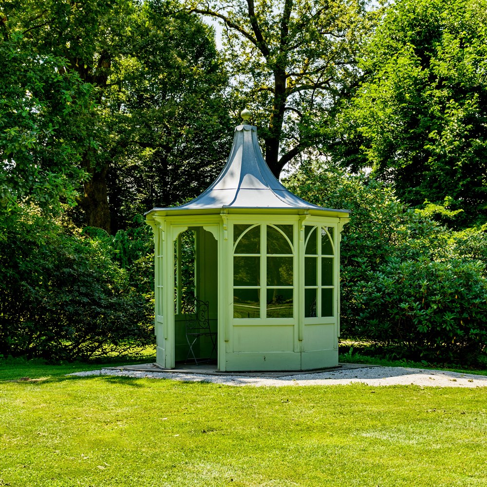 decorative-gazebo-surrounded-by-lush-greenery Decorative gazebo surrounded by lush greenery