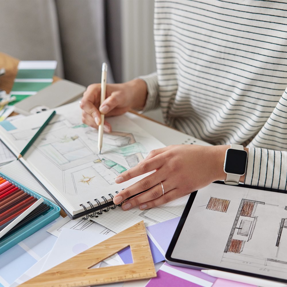 Designer sketching interior on digital tablet