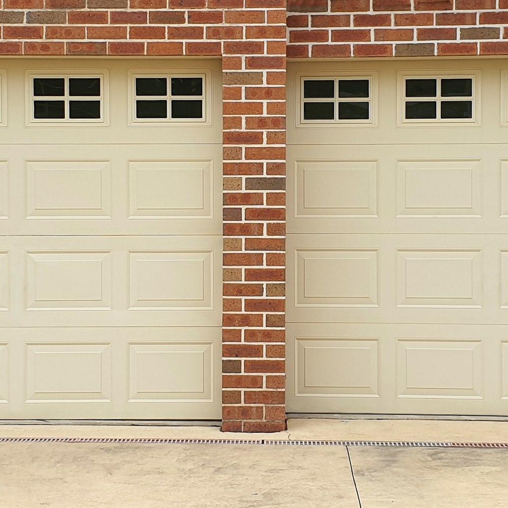 Double garage doors with windows in brick