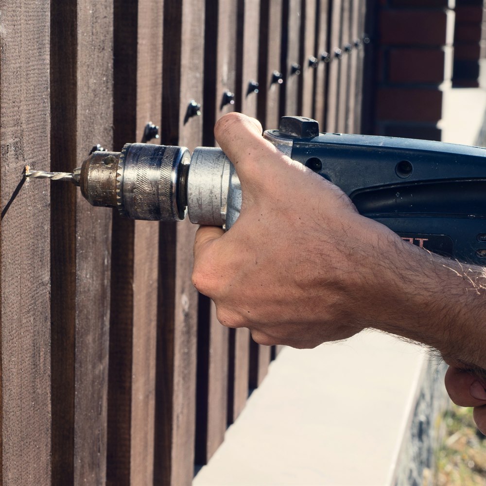 drilling-into-a-wooden-fence-post Drilling into a wooden fence post