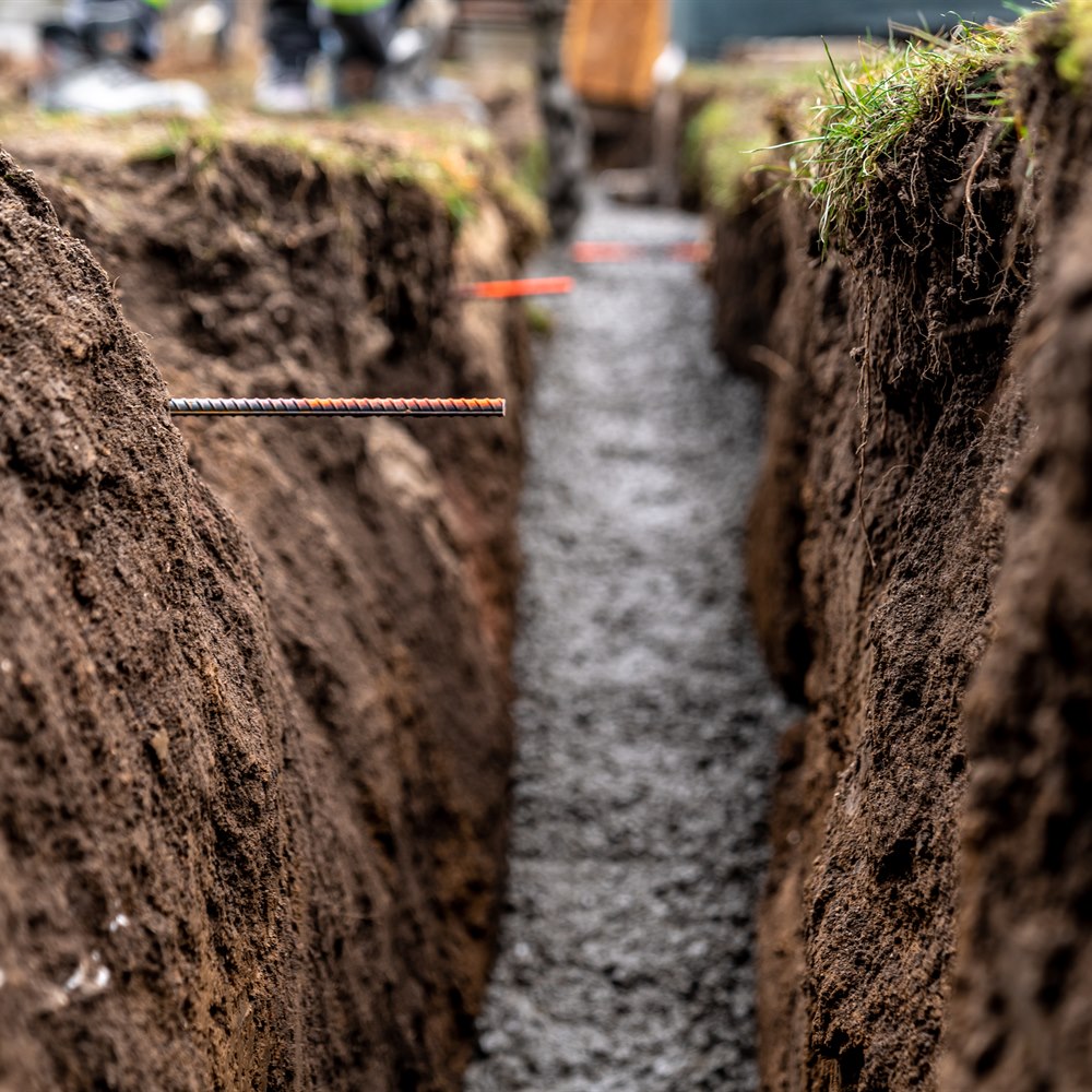Dug trench filled with gravel for construction