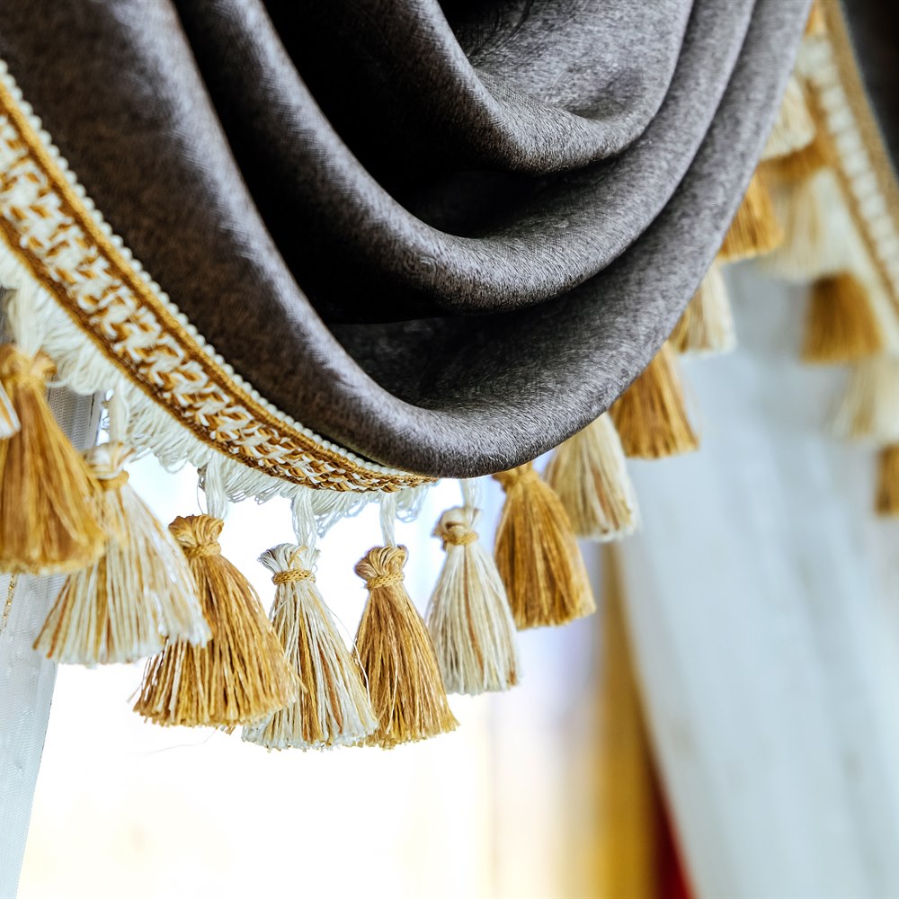 Elegant brown curtain with decorative tassels close