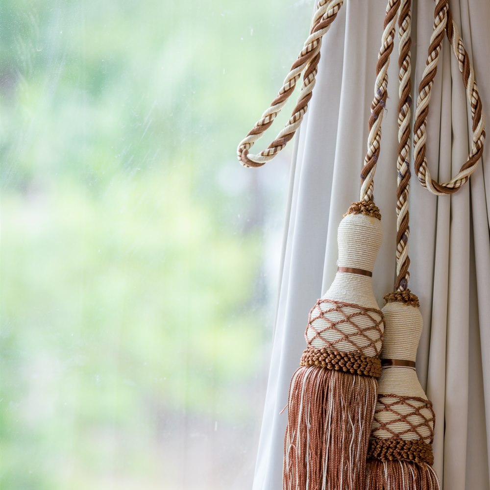 Elegant curtain tieback with tassels and greenery