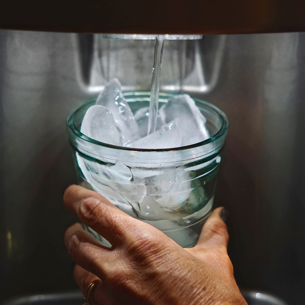 Filling glass with ice from refrigerator ice dispenser