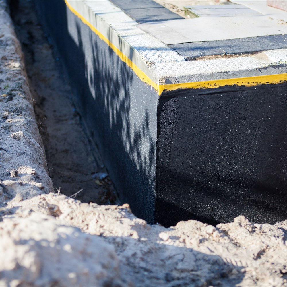 Foundation waterproofing membrane in trench