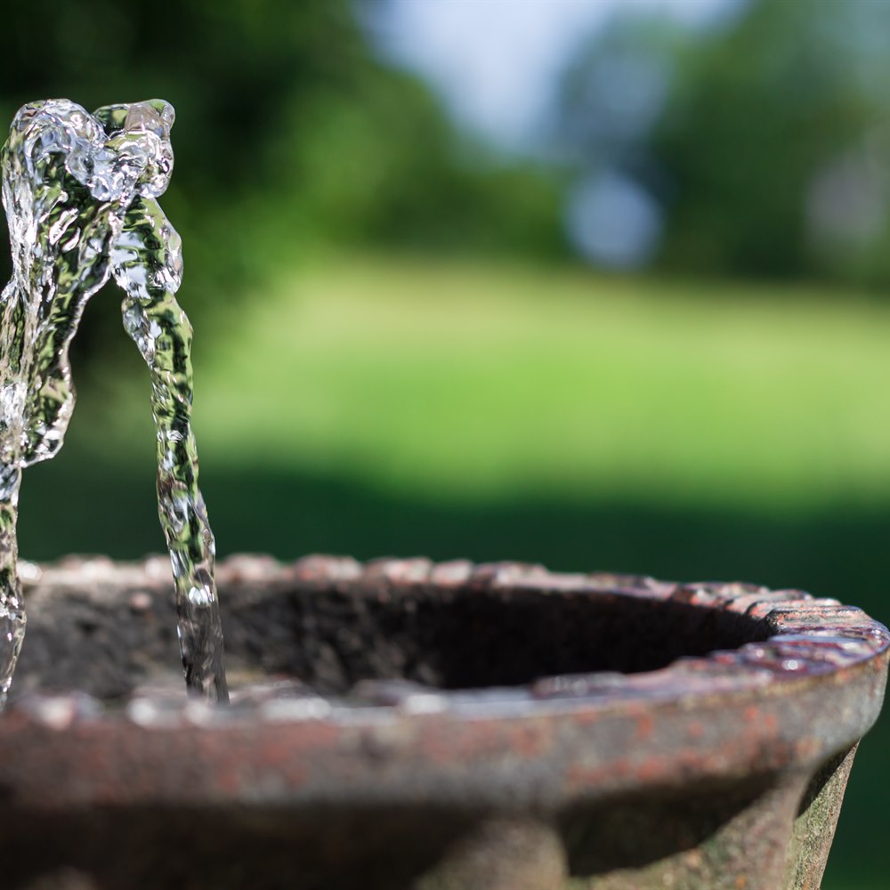 fresh-water-flows-from-outdoor-rustic-fountain Fresh water flows from outdoor rustic fountain