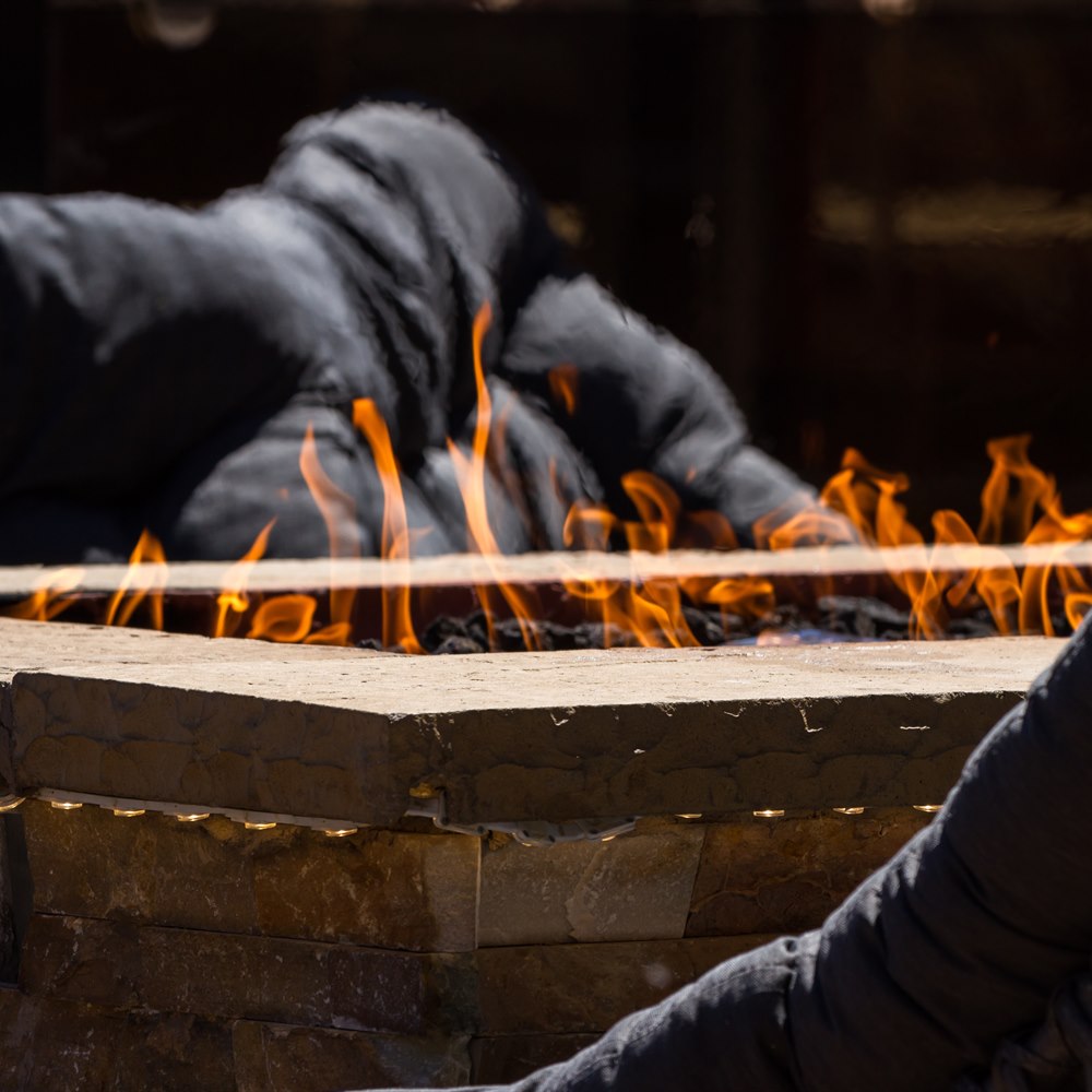 Glowing flames flickering in an outdoor fireplace