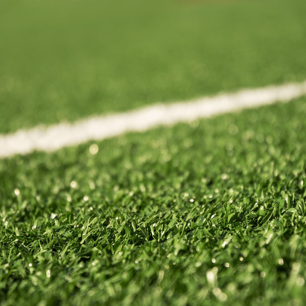 Green artificial turf with a white line