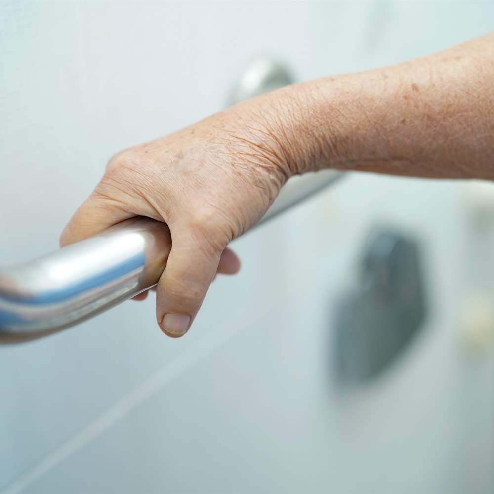 Hand on a bathroom grab bar