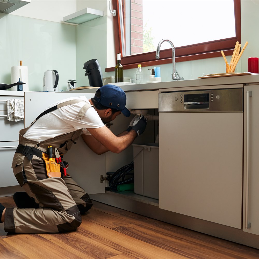 Home repair man working in modern kitchen