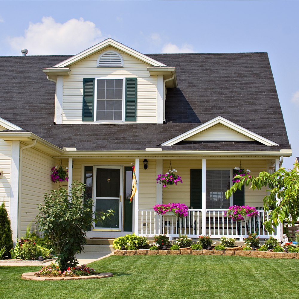 Home with a manicured lawn and beds