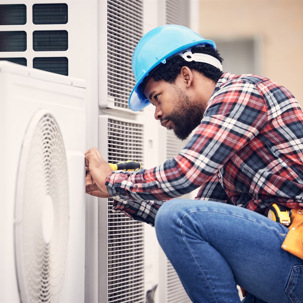 Hvac technician works on commercial air conditioning