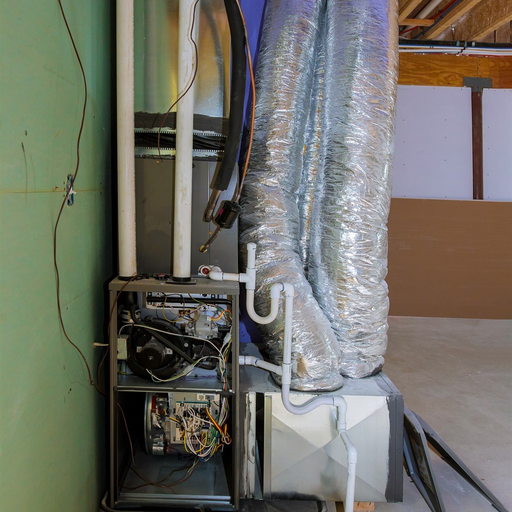 indoor-hvac-unit-with-ductwork-and-pipes Indoor hvac unit with ductwork and pipes