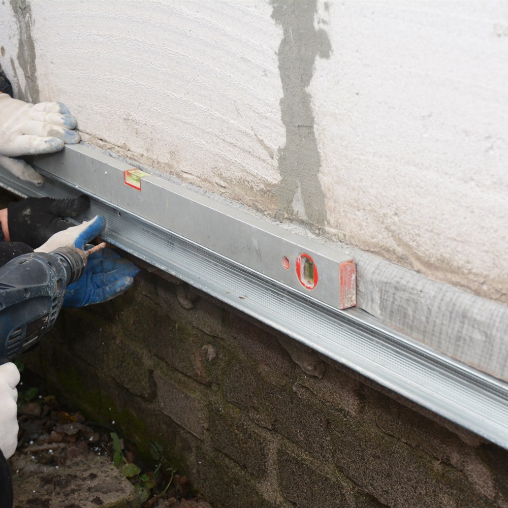 Installing foundation waterproofing trim
