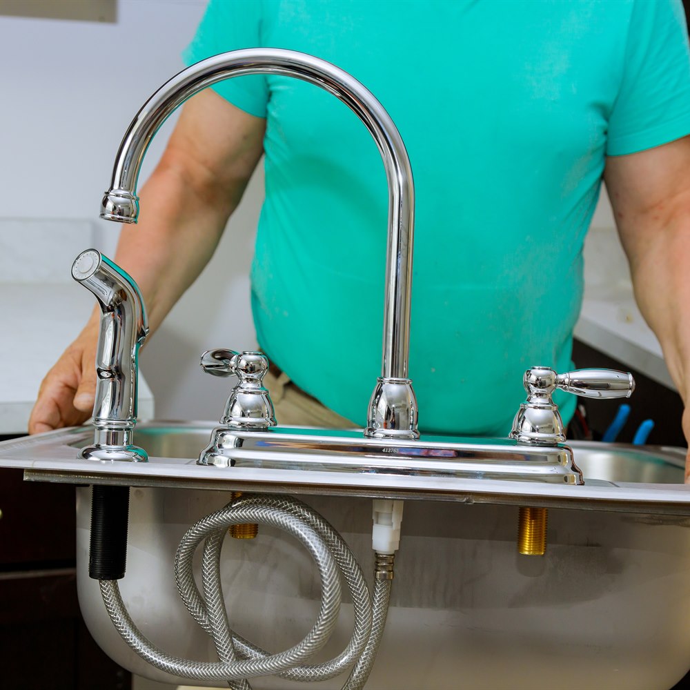 Installing shiny new sink faucet fixtures indoors