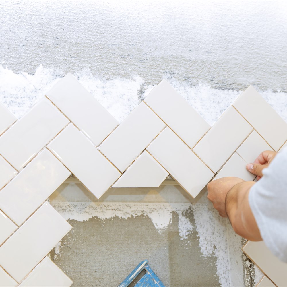installing-white-subway-tile-in-a-herringbone-patt Installing white subway tile in a herringbone pattern