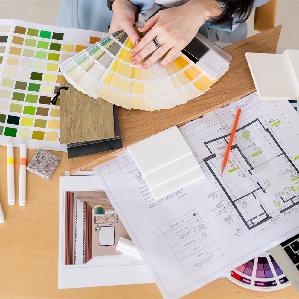 Interior design desk with swatches and plans