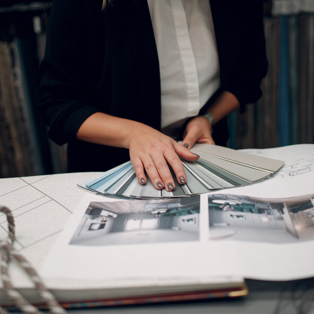 Interior designer with color swatches and blueprint