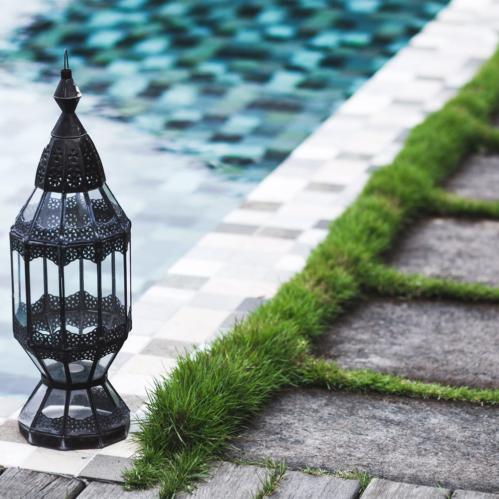 lantern-by-a-pool-with-grass-pavers Lantern by a pool with grass pavers