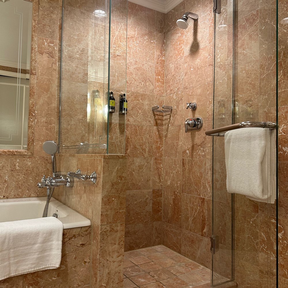 Luxurious modern bathroom with peach marble tiling