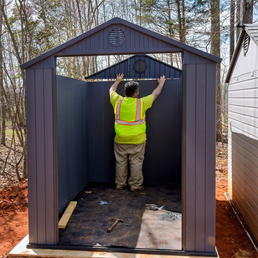 Man assembling new shed in the backyard
