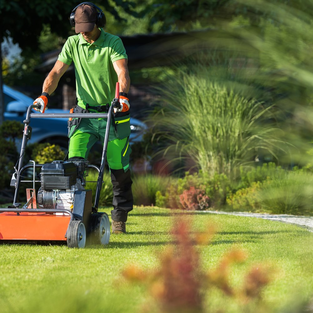 Man mowing lawn in residential neighborhood