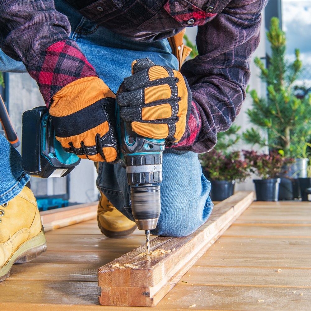 man-using-drill-on-wood-outdoors-during-daytime Man using drill on wood outdoors during daytime