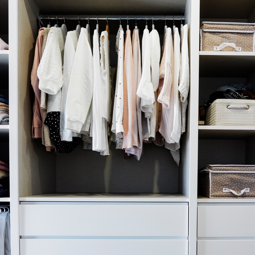 neatly-organized-clothes-in-closet-with-drawers Neatly organized clothes in closet with drawers