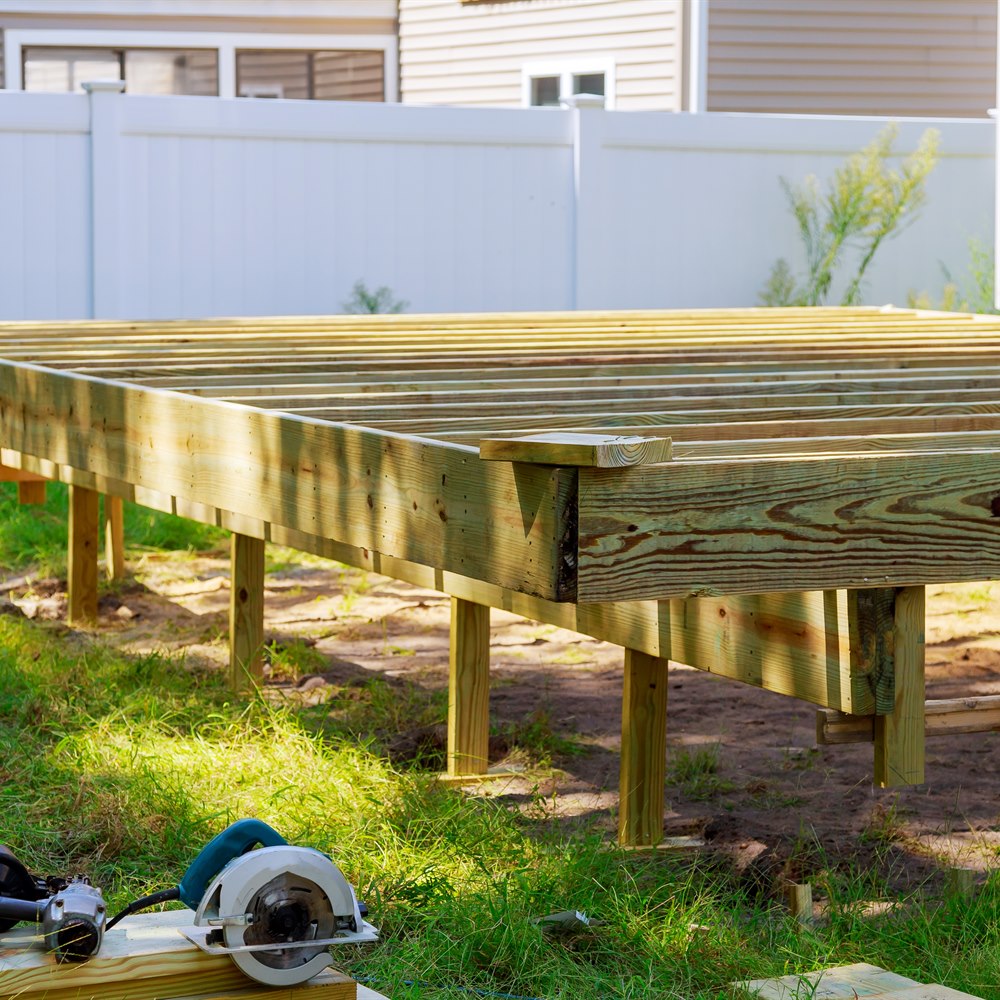 new-deck-construction-in-residential-backyard-sett New deck construction in residential backyard setting