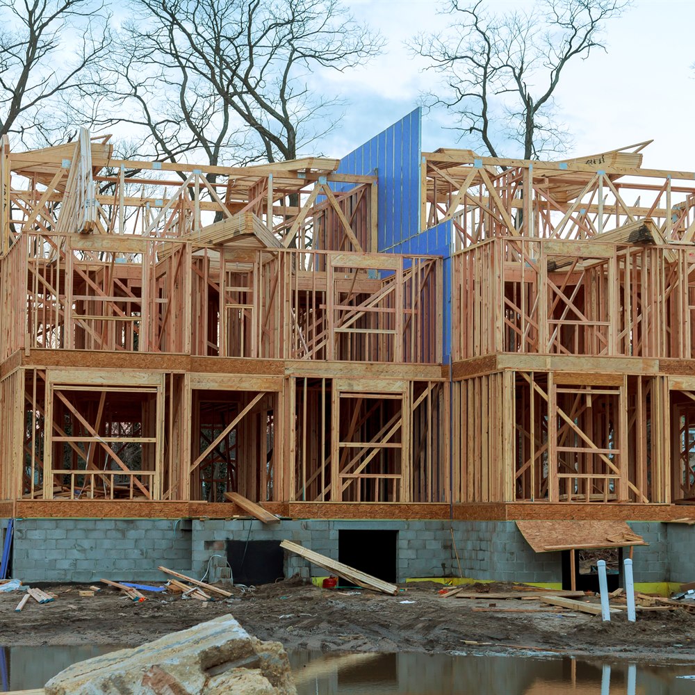 New home construction framework under cloudy sky