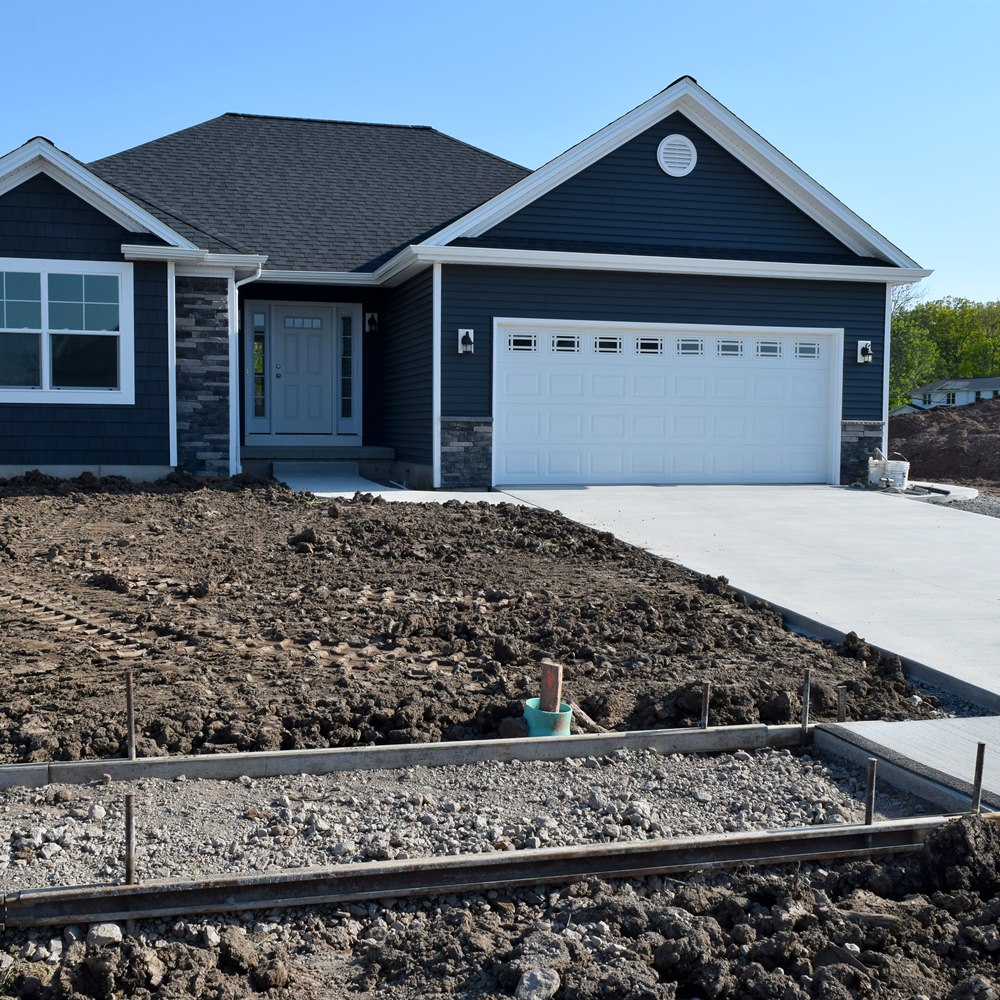 New home with concrete driveway and garage