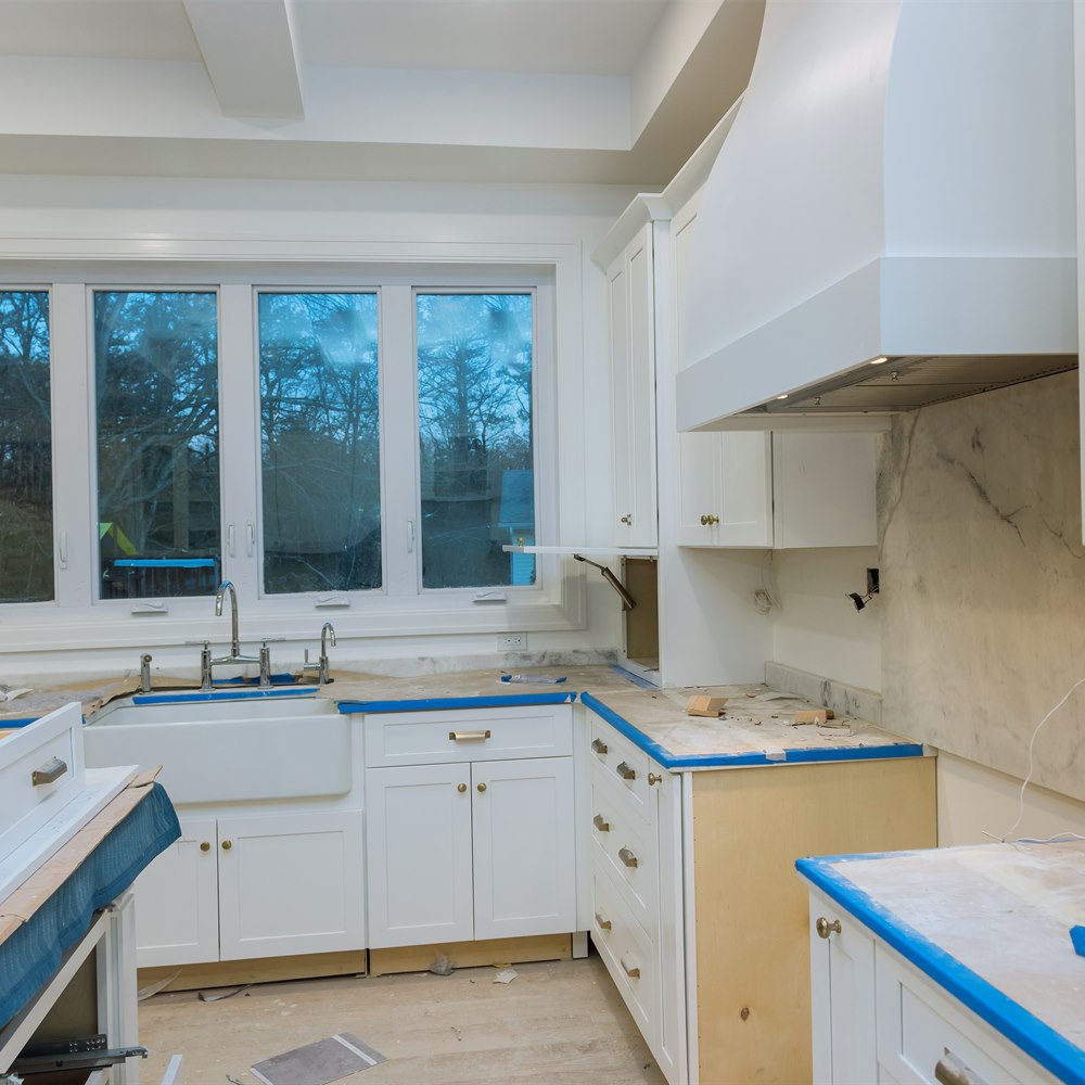 New kitchen renovation with white cabinets and sink