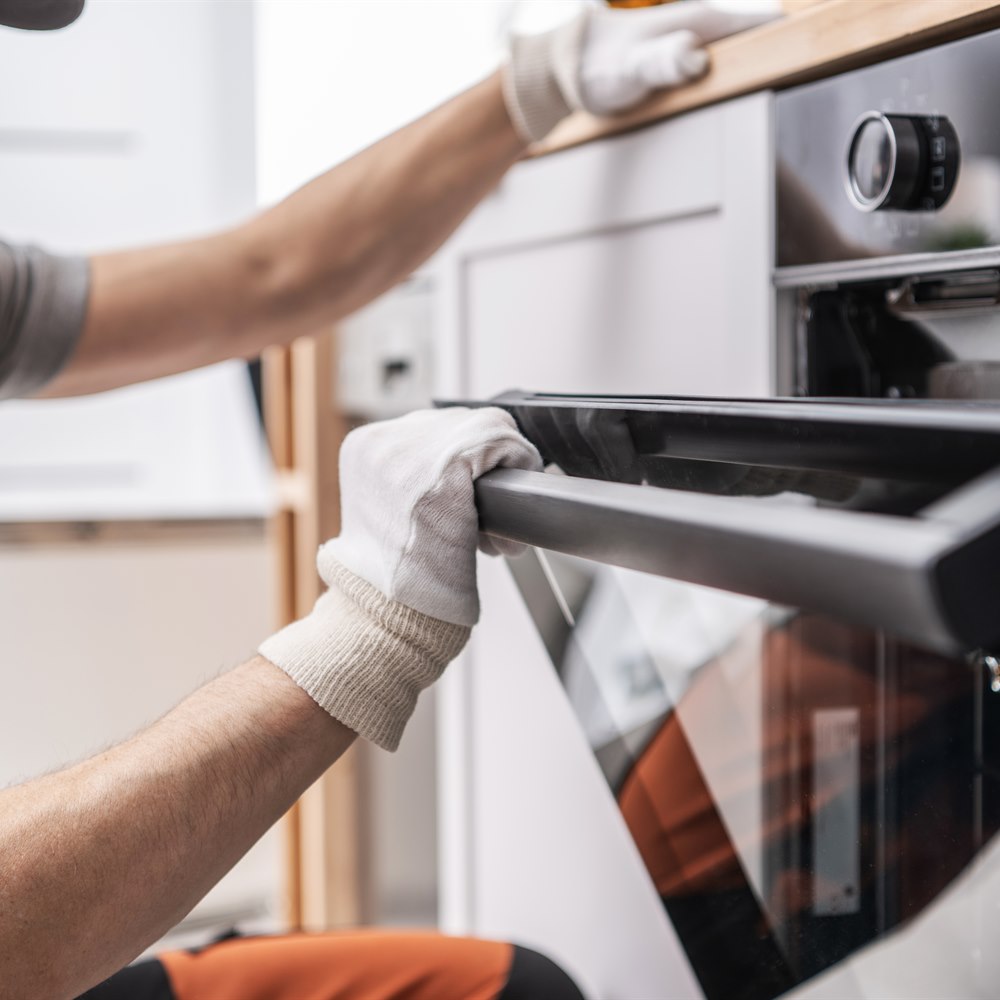 Oven installation by an adult male professional
