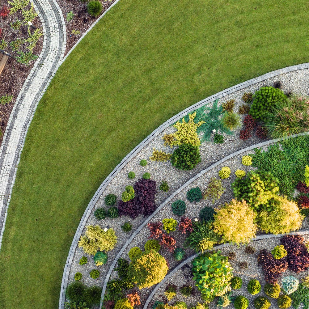 Overhead view of manicured garden with stone pathway